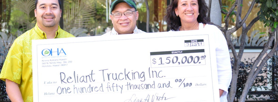 Photo: Reliant Trucking Owners holding a check